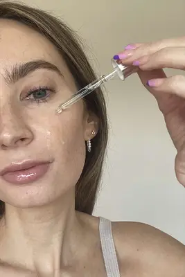 Dr. Dennis Gross Skincare Hyaluronic Marine Hydration Booster Being Applied to the Cheek