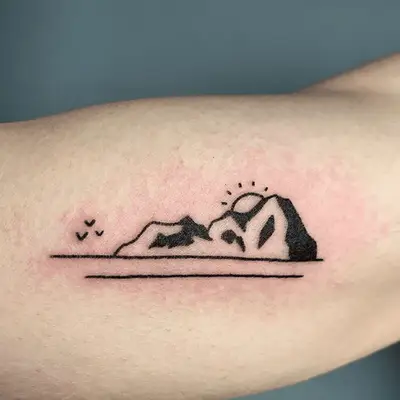 tattoo of a mountain in black ink