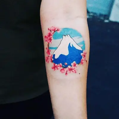 multicolored tattoo of a mountain surrounded by flowers