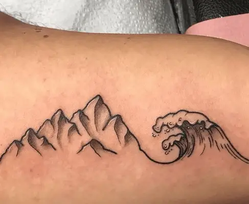 tattoo of a wave and a mountain