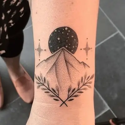 maximalist tattoo of a mountain and moon