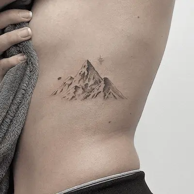 ribcage tattoo of a mountain
