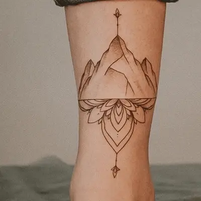tattoo of a mountain and lotus flower