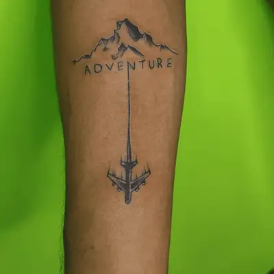 adventure tattoo with mountains and airplane