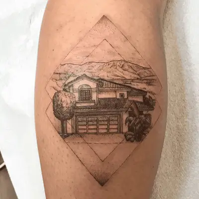 tattoo of a house with mountains in the background