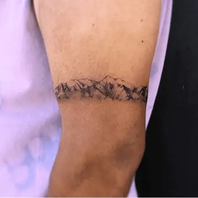 armband tattoo in the shape of a mountain