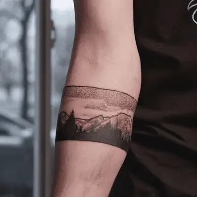 black and white contained mountain tattoo on someone