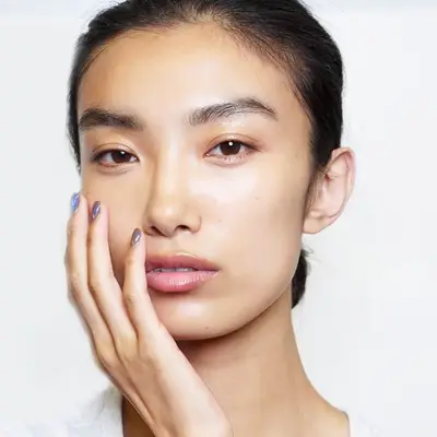 Asian woman with a clear complexion and full brows
