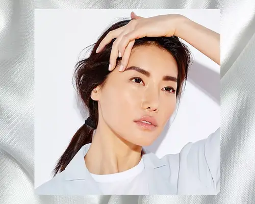 Woman performing face yoga