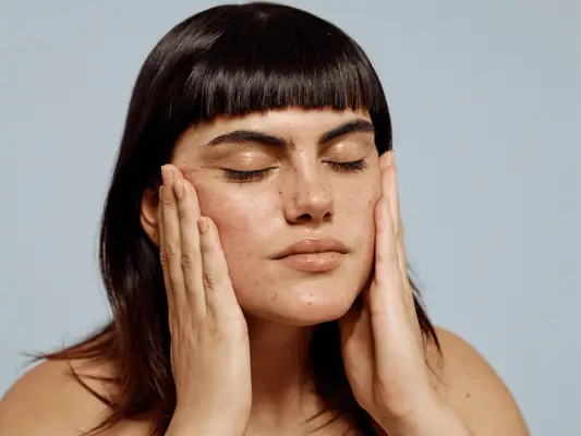 woman touching her face