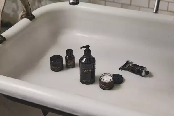 Le Labo grooming products in the bathtub