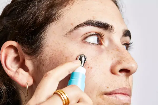 A person applies TULA Eye Renewal Serum