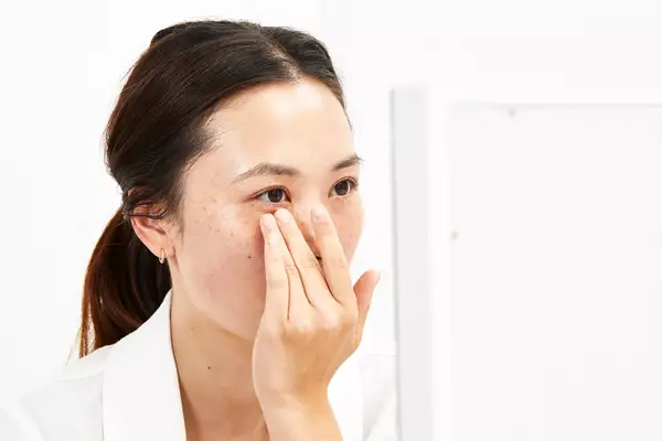 A person applies Dermalogica Biolumin-C Vitamin C Eye Serum