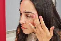 A person applies Beauty of Beauty of Joseon Revive Eye Serum under their eye. 