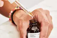 Dropper being removed from The Ordinary Caffeine 5% + ECGC Depuffing Eye Serum bottle