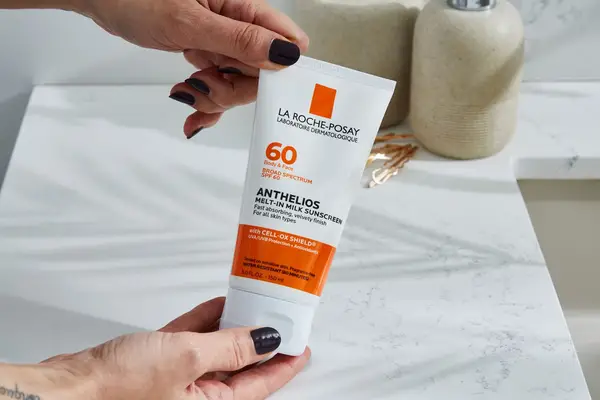 a person holding the La Roche-Posay Anthelios Melt-In Milk Sunscreen