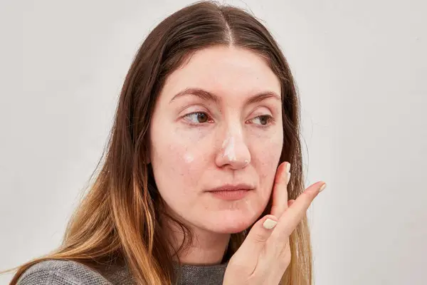 Person applying La Roche-Posay Toleriane Double Repair Face Moisturizer UV With SPF 30 on their face