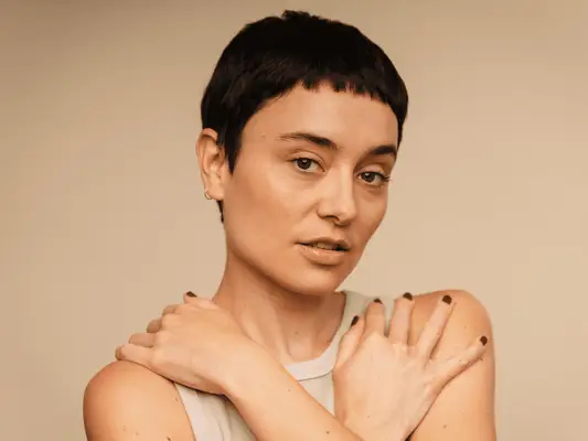 Close up of a woman with a pixie haircut.