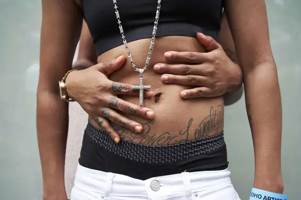 closeup of young qpoc hugging 