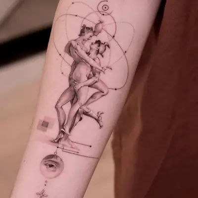 Close-up of tattoo of two ancient figures embracing