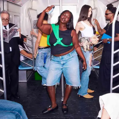 Model spraying face mist on the subway