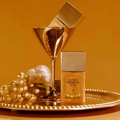 Vacation Shimmer Oil in a gold martini glass