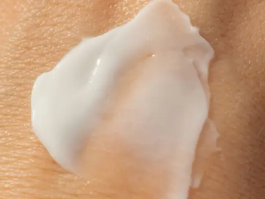 Close up of a swatch of an exfoliant on the back of a hand