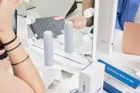 Bottle of Fenty Skin Hydra Vizor Invisible Moisturizer Broad Spectrum SPF 30 Sunscreen set in front of a mirror