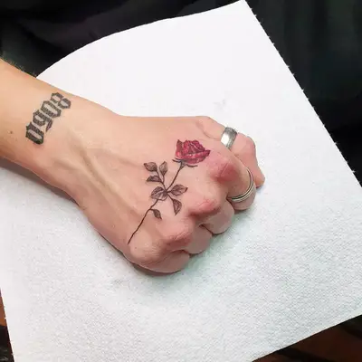 Intricate rose hand tattoo