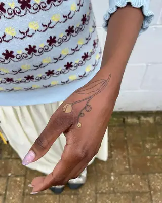 Yellow tulib hand tattoo on Black skin