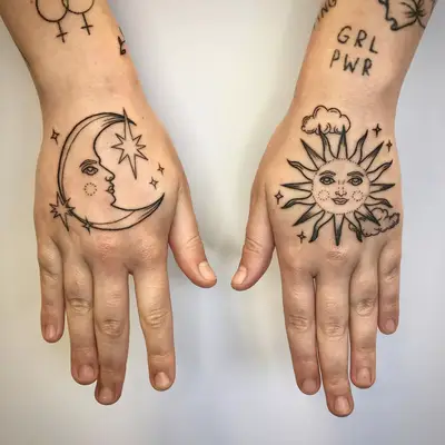 Sun and moon tattoos on back of hands