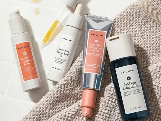 naturium skincare products on bathroom couunter