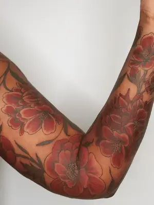 red floral arm tattoo