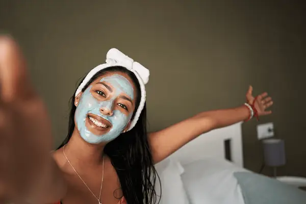 girl taking selfie wearing face mask