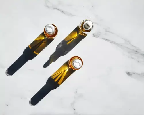 non-comedogenic oil vials on marble counter top