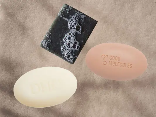 Bar Soaps on a textured water and sand background