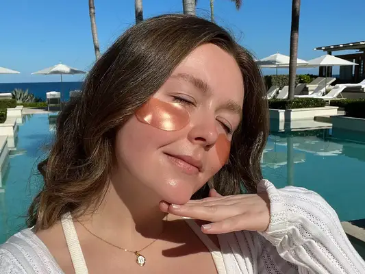 woman with eye gels on at the pool