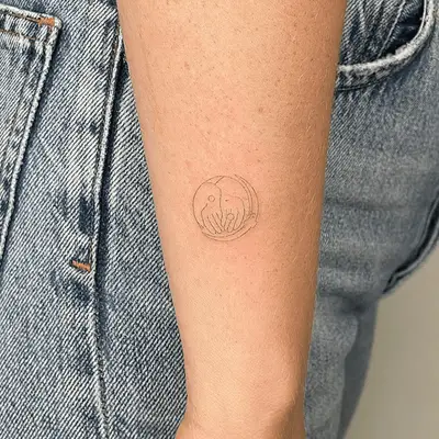 Close up of a double hand yin and yang tattoo accented with a crescent moon.