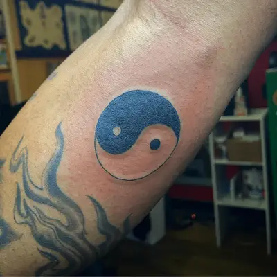 Close up of wrist yin-yang symbol.