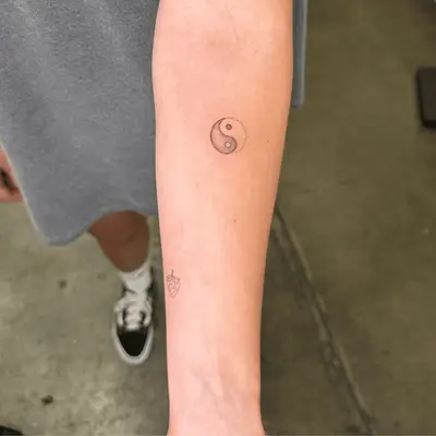 Close up of a yin-yang symbol with dotted line half.