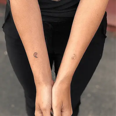 Close up of yin and yang halves on two arms.