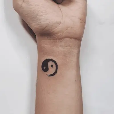 Close up of a wrist with a fluid motion yin-yang symbol