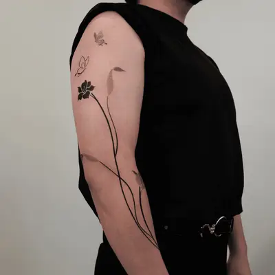 long step flowers and butterflies tattoo on full arm