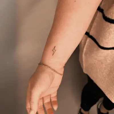 small lightning bolt tattoo on inner wrist