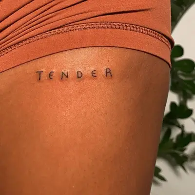 all caps minimal word tattoo that says tender