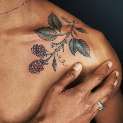 colored shoulder tattoo of vine and grapes 