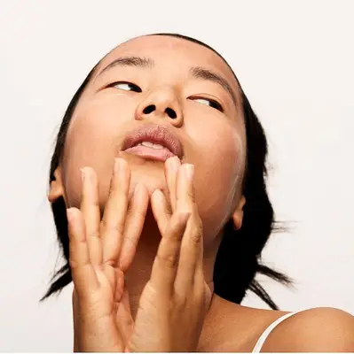 Person applying face lotion