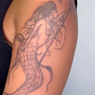 black ink tattoo of mermaid with seashell bra