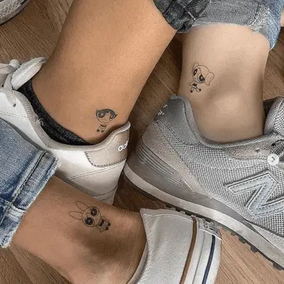 Close up of four wrists with matching diamond tattoos