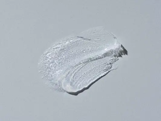 a swatch of petroleum jelly on a gray background